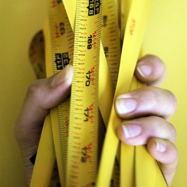 Image of hand holding tape measures